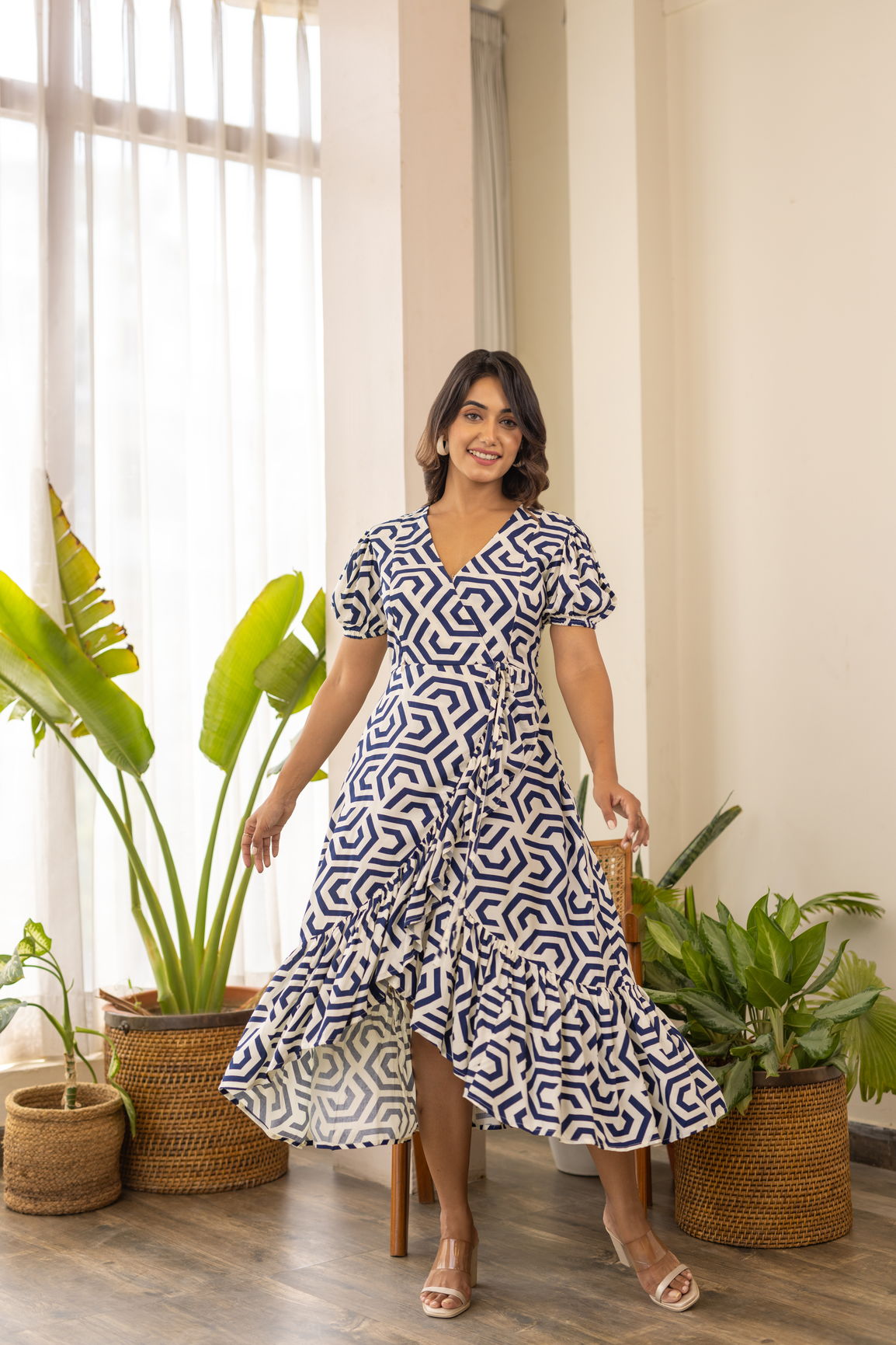 Stylish woman in a geometric patterned wrap nursing maxi dress.