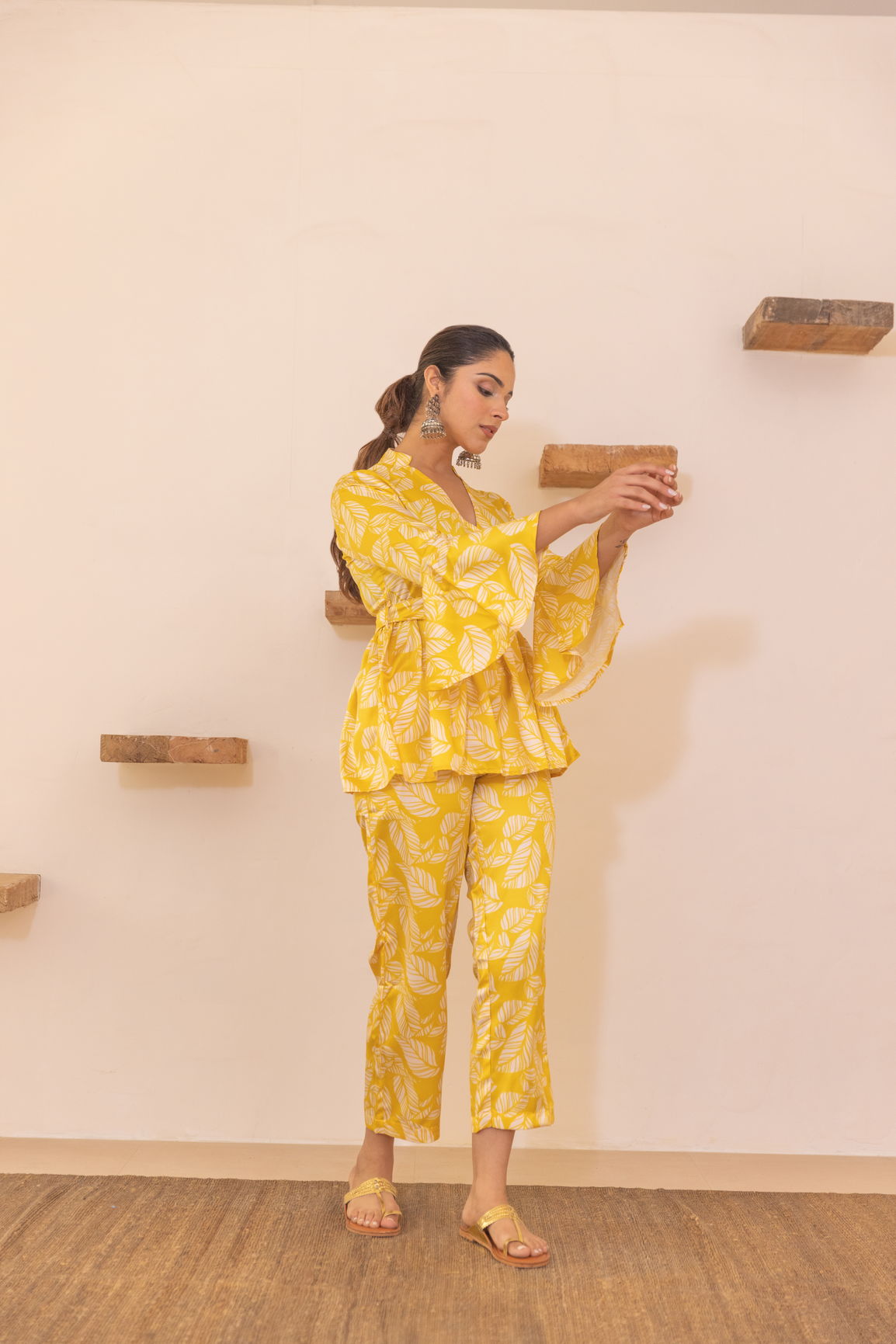 Yellow tropical satin co-ord set with floral pattern, model posing elegantly.