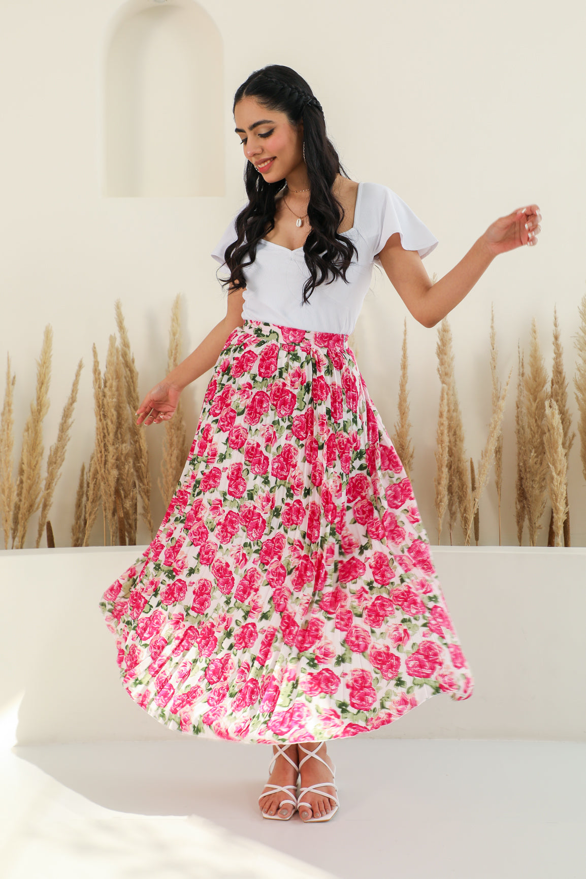 Floral pleated co-ord set with stylish white top and vibrant skirt.