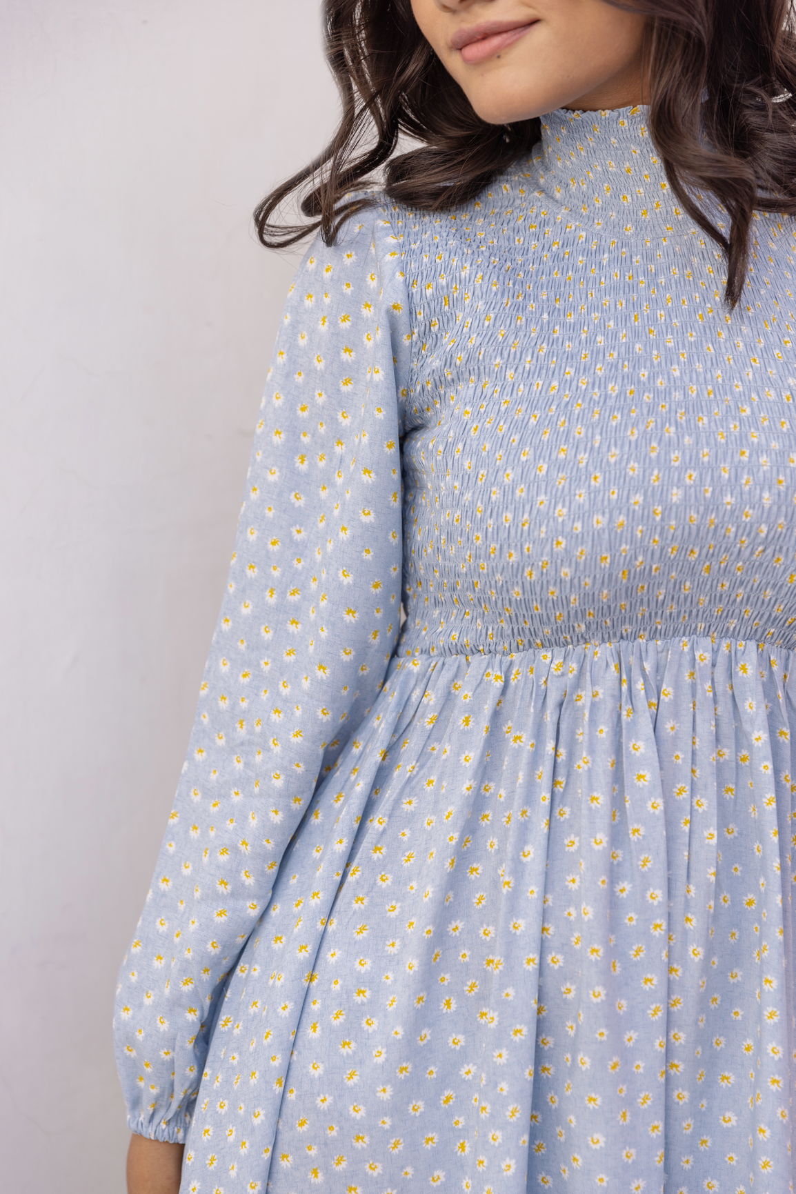 Cotton smocked midi dress in blue with floral patterns.