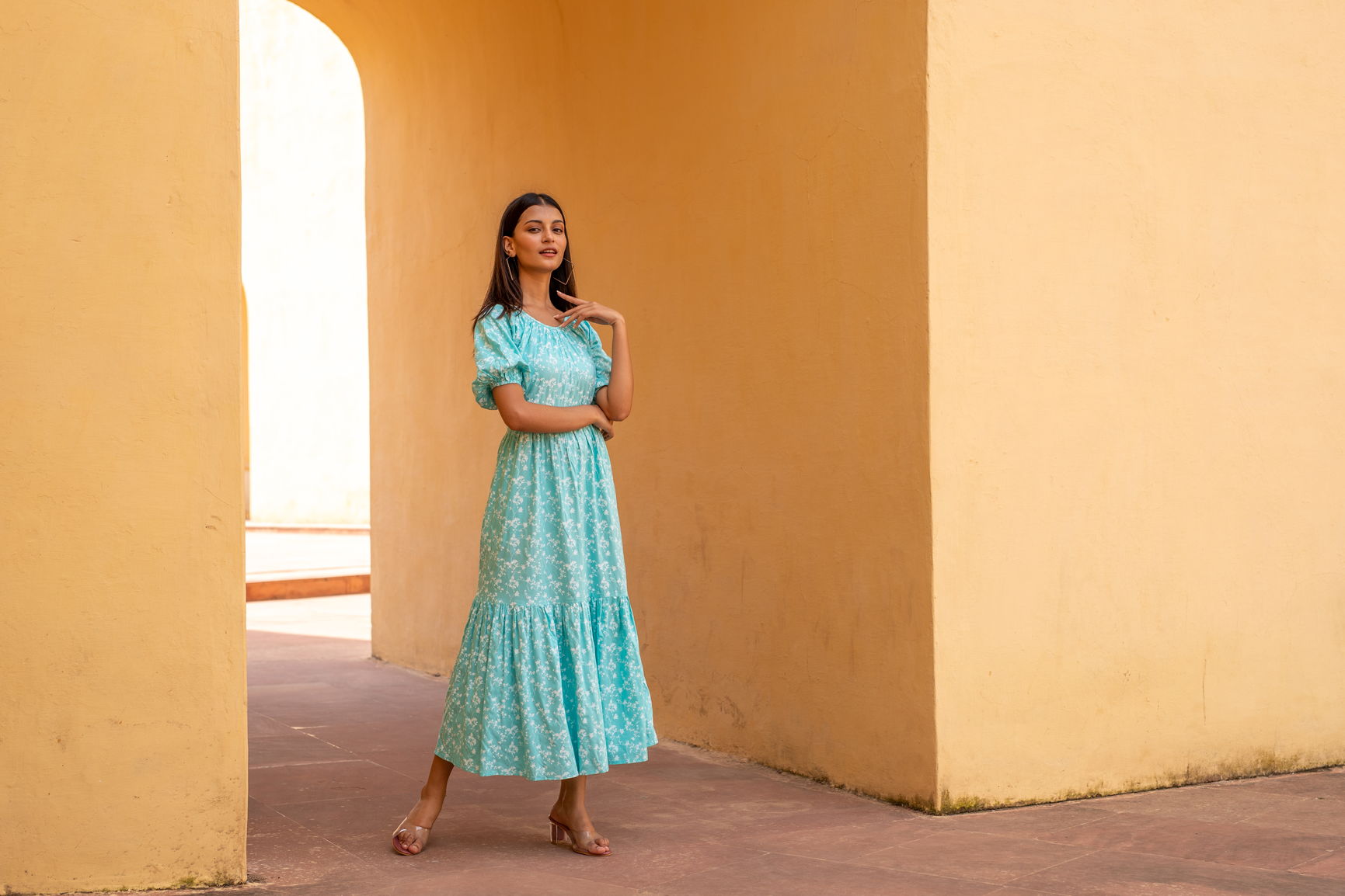 Model wearing Sea Blue Floral Maxi dress in sunny setting.