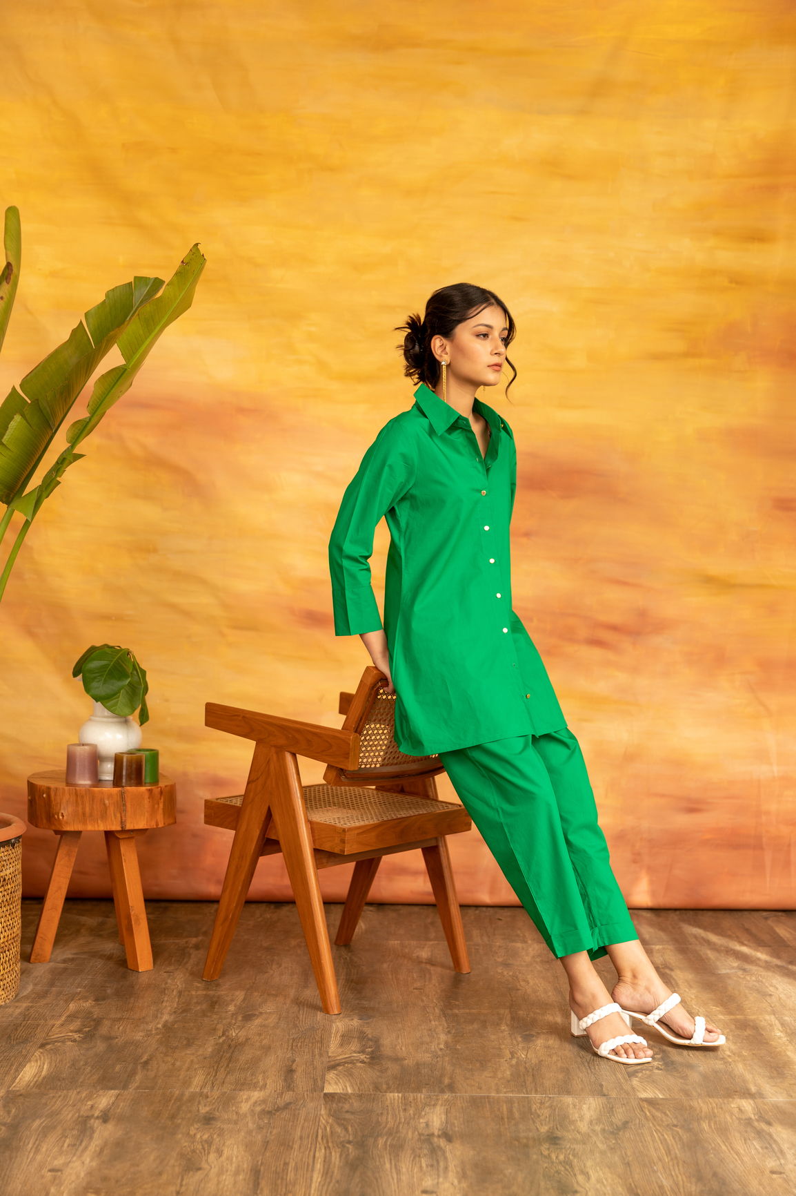 Stylish woman in green Shamrock co-ord set against a vibrant backdrop.