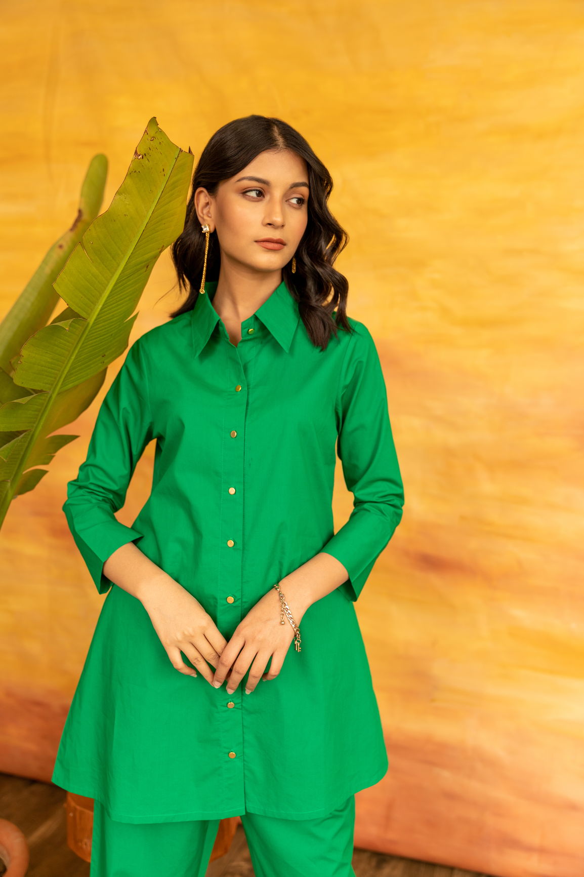 "SHAMROCK CO-ORD SET on model with green outfit against yellow backdrop."