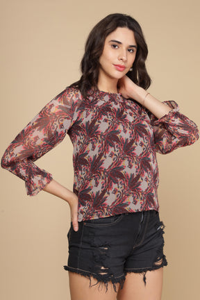 Multi off-shoulder top with floral pattern and sheer long sleeves.