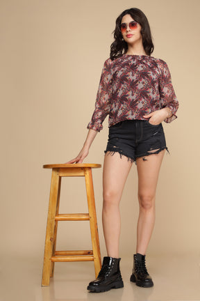 Model wearing a stylish multi off-shoulder top with shorts.