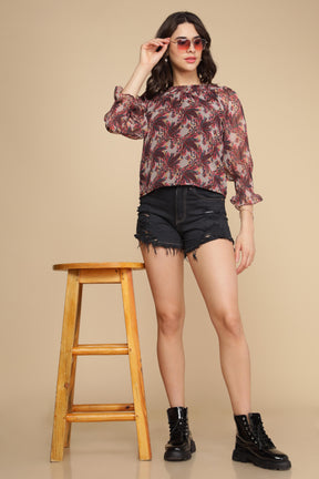 Stylish multi off-shoulder top with floral design and black shorts.