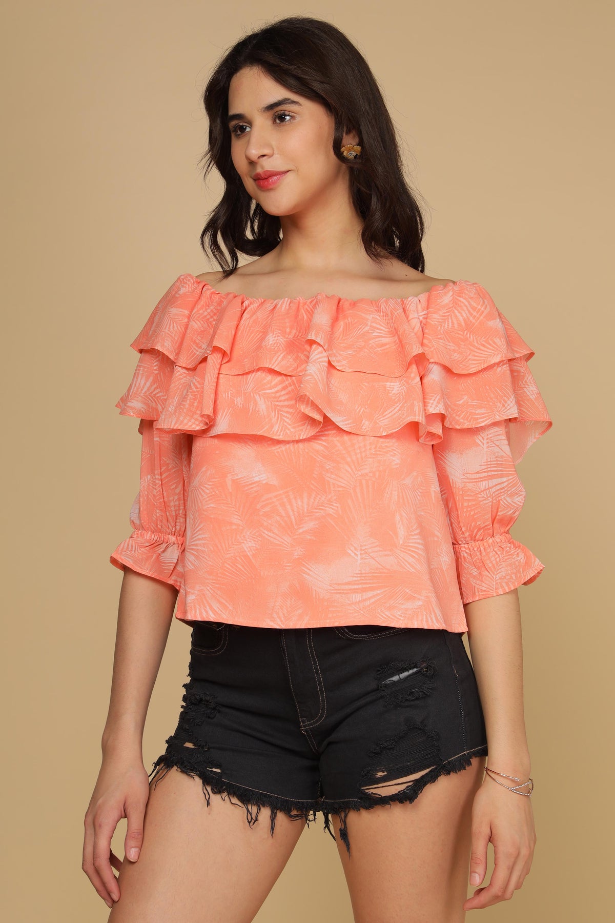 Peach printed top with ruffled sleeves and stylish design.