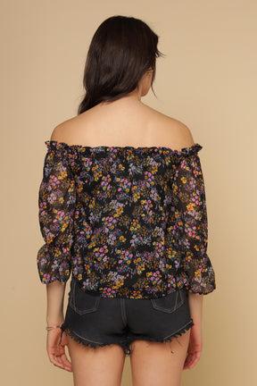 Multi floral women's top with off-shoulder design and puffed sleeves.