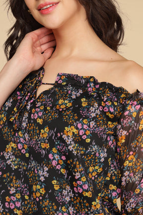 Multi floral top with colorful patterns and off-the-shoulder design.