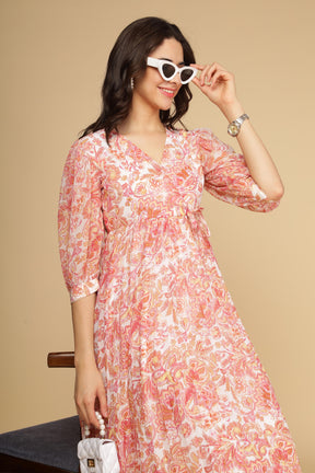 Elegant woman wearing PLEATED MOTIF MAXI dress with floral design.