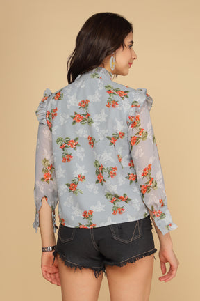 Pastel blue ruffle shirt top with floral pattern and stylish design.