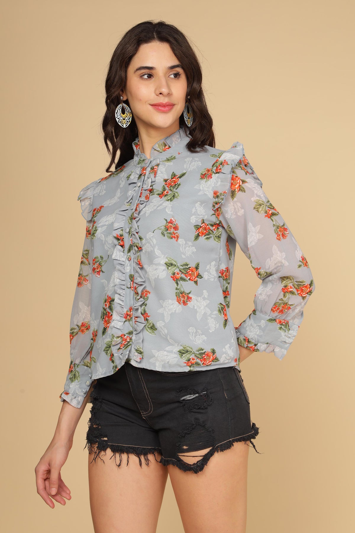 Pastel blue ruffle shirt top with floral design and stylish sleeves.