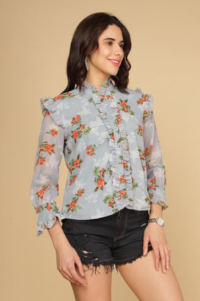 Pastel blue ruffle shirt top with floral print and stylish design.