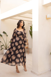 Black balloon sleeve dress featuring floral design, perfect for stylish occasions.