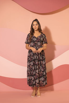 Black floral maxi dress displayed against a pastel wave backdrop.