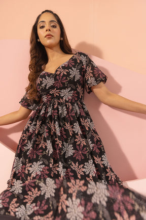 Black floral maxi dress with short sleeves and a flowing silhouette.