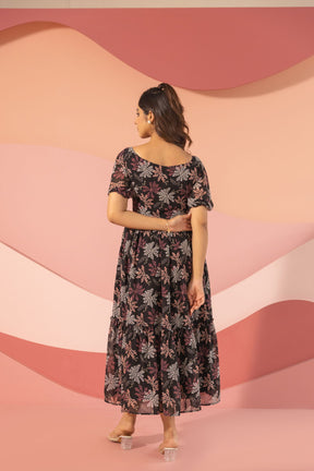 Black floral maxi dress with tiered design, elegant and stylish.