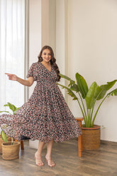 Black floral print nursing maxi dress in a bright indoor setting.