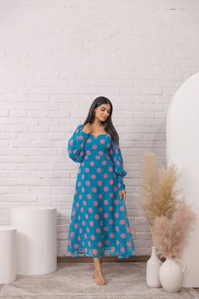 Blue polka dot maxi dress with long sleeves and flattering silhouette.
