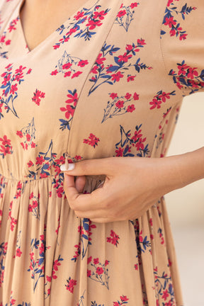Floral nursing maxi dress with adjustable button closures for mothers.