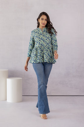 Green cotton top with floral pattern, stylish outfit for women.
