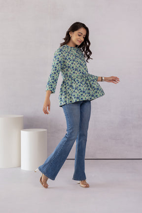 Model showcasing a stylish green cotton top with floral print.