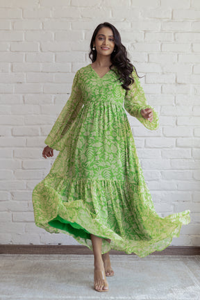 Green and yellow floral maxi dress with long sleeves in motion.