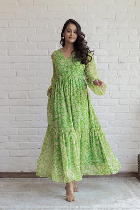 Green and yellow floral maxi dress on a model against a white background.
