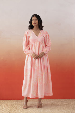 Model wearing Marble Maxi dress in pink with flowing sleeves.