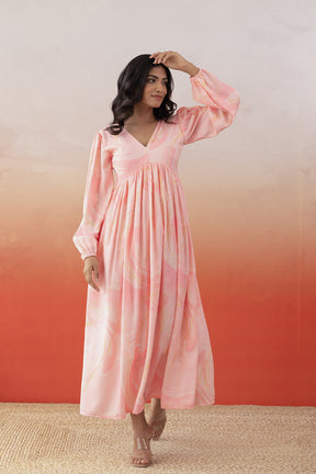 Elegant pink marble maxi dress on model against gradient background.