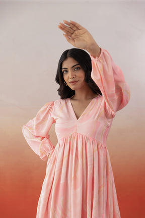 Model wearing MARBLE MAXI dress in pink with flowing sleeves.