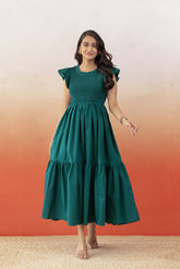 Emerald green cotton maxi dress with ruffle sleeves and tiered skirt.