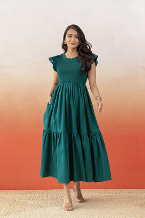 Emerald green cotton maxi dress with ruffled sleeves and pockets.