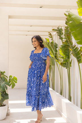 Woman wearing Electric Blue Tropical Maxi dress in sunny environment.