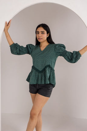Emerald green cotton top with stylish puffed sleeves and peplum design.
