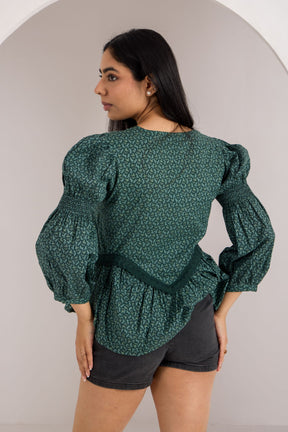 Emerald green cotton top with stylish puff sleeves and ruffled hem.