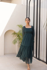Emerald green chiffon maxi dress paired with stylish accessories.