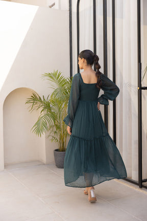 Emerald green chiffon maxi dress with puffed sleeves and tiered design.