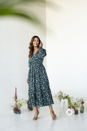Emerald green floral smocked maxi dress model in a bright studio.