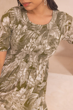 Green tropical smocked cotton maxi dress with floral print detail.