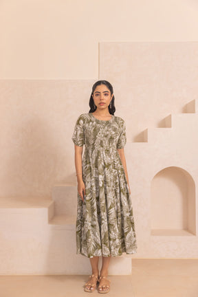 Green tropical smocked cotton maxi dress on model, stylish and elegant.
