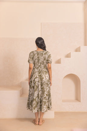 Green tropical smocked cotton maxi dress, stylish back view.