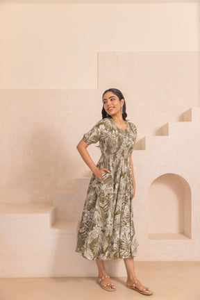 Green tropical smocked cotton maxi dress styled elegantly on a model.