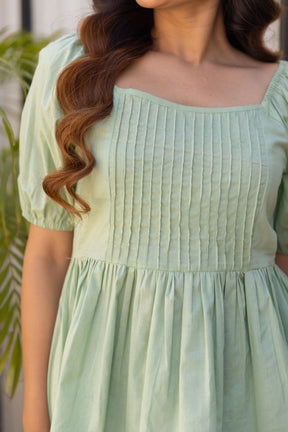 Lemon green cotton top with textured detailing and puff sleeves.