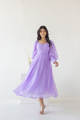 Lilac Princess Maxi dress model showcasing vibrant purple design and flowing silhouette.