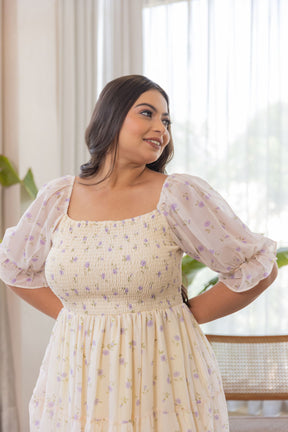 Elegant floral dress featuring puff sleeves in soft pastel colors.