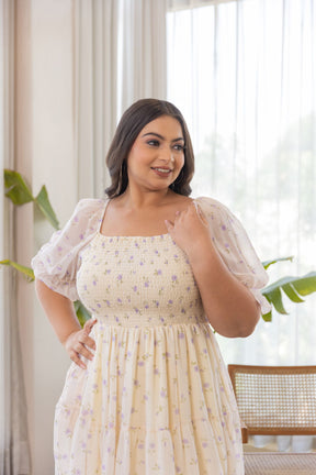 Model wearing MINIMAL MAXI - POLAGO PLUS floral dress in bright setting.