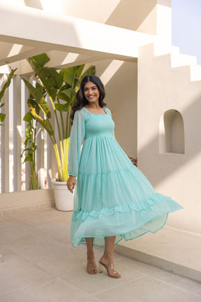 Mint green chiffon maxi dress with tiered design, perfect for summer outings.