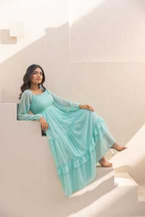 Mint green chiffon maxi dress styled in a sunny setting.