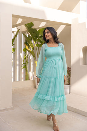Mint green chiffon maxi dress with elegant puff sleeves.